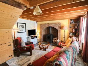a living room with a couch and a fireplace at Teach Feirme in Clonakilty