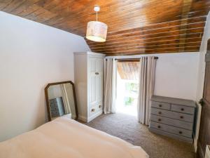 a bedroom with a bed and a mirror and a dresser at Teach Feirme in Clonakilty