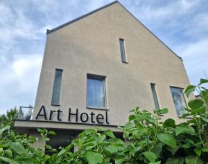 a building with a sign for an art hotel at Art Hotel Podebrady in Poděbrady