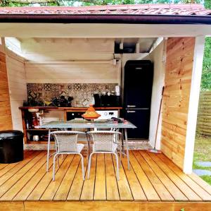 a patio with a table and chairs on a deck at Cabanoù Lodge & Spa in Messanges