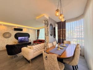 a living room with a dining table and a couch at SA Apartments! 2BR Flat 100m to Cleopatra Beach in Alanya +29 photos