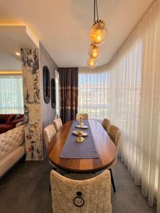 a dining room with a wooden table and chairs at SA Apartments! 2BR Flat 100m to Cleopatra Beach in Alanya