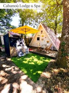 a backyard with a tent and green grass at Cabanoù Lodge & Spa in Messanges