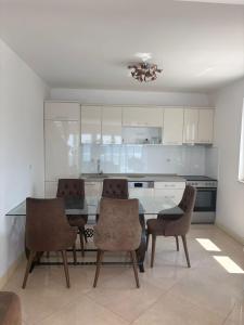 a kitchen with a table and chairs in a room at Haus am Strand in Bar