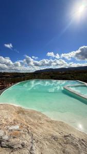 a large pool of blue water on top of a hill at Nazareth Cânion in Buriti dos Montes