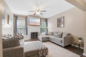a living room with a couch and a fireplace at Group-Ready 6BR Gem in Central Lafayette in Lafayette
