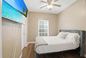 a bedroom with a bed and a ceiling fan at Group-Ready 6BR Gem in Central Lafayette in Lafayette +9 photos