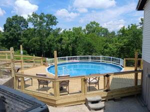 a pool on a deck with a fence around it at 5BR Home Pool, hot tub, pet friendly by ARK Experience in Williamstown