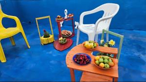 a toy table with bowls of fruit on it at Sea promenade Hostel Art Apartment in El Mîna
