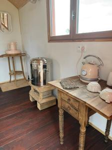 a kitchen with a table with a tea kettle on it at Chambre Panoramique Bellevue in Bellegarde-Adoulins