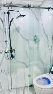 a bathroom with a shower and a toilet at Studio unit in San Fernando, The Hideaway in San Fernando +13 photos