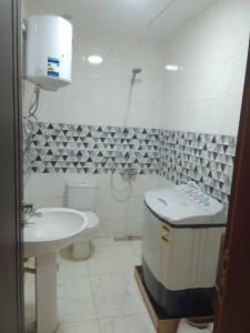 a bathroom with a toilet and a sink at Abu sobh holiday in Alexandria