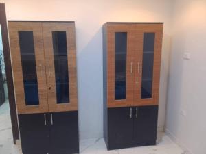 two wooden lockers in a room with a wall at Abu sobh holiday in Alexandria