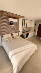a large white bed in a large room at Studio cosy Plage à pied Parking in La Grande Motte