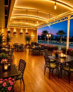 a restaurant with tables and chairs with a view at Smart Gate Hotel Apartments سمارت غيت للشقق الفندقية in Jazan