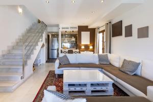 a living room with a couch and a table at Sunny Holidays Mojácar Pool House in Mojácar