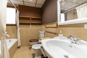 a bathroom with a sink and a toilet at Sunny Holidays Mojácar Pool House in Mojácar