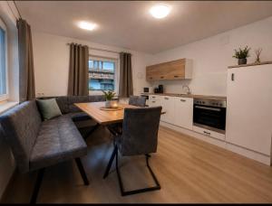 a kitchen and living room with a table and a couch at Haus Antonia in Zams