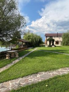 a garden with a stone walkway and a house at Souvenir in Isaccea