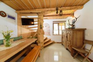 a living room with a large wooden table and benches at Doru' Bucovinei in Moldoviţa