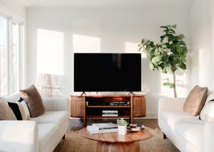 a living room with a flat screen tv on a table at Marshfront 5BD Oasis Pool Yard & Steps to Beach in Folly Beach