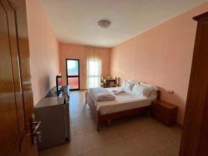 a bedroom with a bed and a desk in a room at Hotel Klajdi in Peshkopi +12 photos