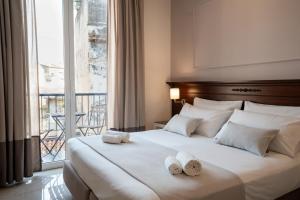 a bedroom with a large bed with towels on it at Ad Maiora Elegant Rooms in Palermo +95 photos
