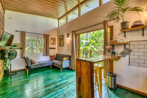 a living room with a counter and a table at Bocas Stoked Monkeys in Bocas Town