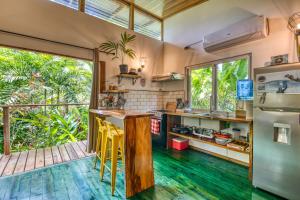 a kitchen with green floors and a large window at Bocas Stoked Monkeys in Bocas Town