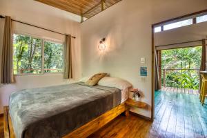 a bedroom with a large bed and a large window at Bocas Stoked Monkeys in Bocas Town +25 photos