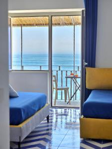 a room with two beds and a view of the ocean at Oasi Relais in Vico Equense +147 photos