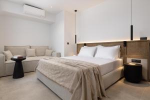 a bedroom with a large bed and a couch at Karavel Suites - Old Town Boutique Rooms in Rhodes Town