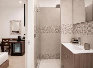 a bathroom with a shower and a sink at Ad Maiora Elegant Rooms in Palermo