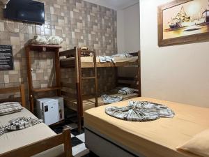 a room with several bunk beds in a room at Pousada Castro in Aparecida +24 photos