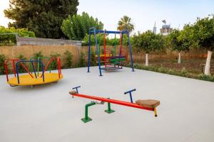 a group of playground equipment on a concrete ground at maison de rivière in Afantou