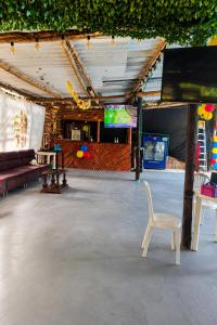 a stage with a chair and a couch and a table at Huiltana ecohotel&resort in Guataquí