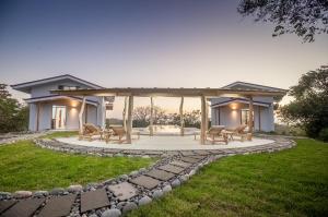 a house with a pavilion in the middle of a yard at Area 101 in Playa Pelada