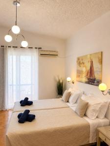 two beds in a bedroom with two towels on them at Gennadi Sun Apartments 500m from the beach in Gennadi