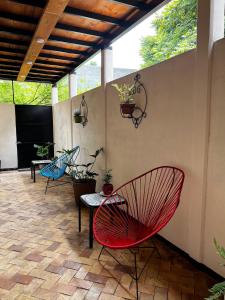a patio with two chairs and a table with plants at Luffa Hostel in Santa Lucía