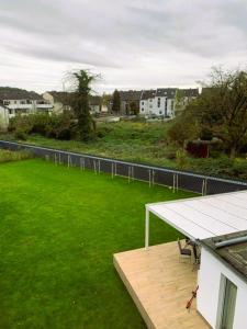 a balcony with a table and a field of grass at Schickes Apartment in Herten