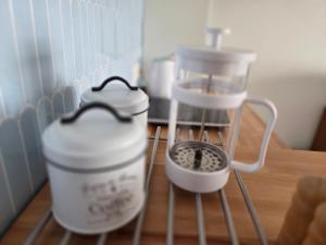 two plastic containers sitting on a shelf in a kitchen at Apartament Gruba Foka in Hel