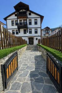 a house with a fence and a stone walkway at Geyikli Konak in Mudurnu