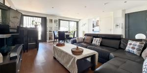 a living room with a couch and a table at Le Balzac - 2 Chambres - Balcon in Tours