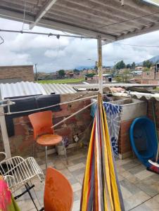a patio with orange chairs and an umbrella at Hospedaje Patty Cajicá in Cajicá