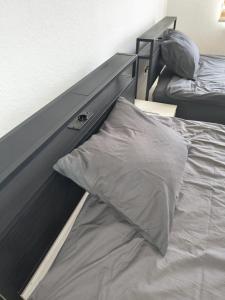a bed with a dresser and a pillow on it at Schickes Apartment in Herten