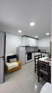 a kitchen with a bed and a table and chairs at Kloa Apartments in Orikum