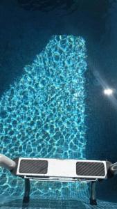 a swimming pool with a bench in the water at Djerba Moon in Djerba