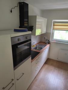 a kitchen with a sink and a stove top oven at Schickes Apartment in Herten