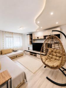 a living room with a rattan chair in a room at Imperium DK Apartament in Giurgiu
