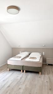 a bedroom with a bed and a white ceiling at Koło Wody - dom dla 6 osób in Sadków